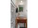 Powder room with bowl sink, wood cabinet and floral wallpaper at 4350 Sylvan Rd, Indianapolis, IN 46228
