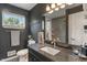 Modern bathroom with dark walls, stylish vanity, and mosaic-tiled shower in background at 4350 Sylvan Rd, Indianapolis, IN 46228