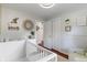 Bright Bedroom with white furniture, wood floors, and decorative wall accents at 4350 Sylvan Rd, Indianapolis, IN 46228