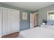 Bedroom showcasing a large closet, hardwood floors, and calming blue walls at 4350 Sylvan Rd, Indianapolis, IN 46228