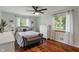 Cozy bedroom with light walls, wood floors and natural light at 4350 Sylvan Rd, Indianapolis, IN 46228