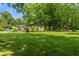 Ranch style house showcasing its lush, green front lawn and mature trees at 4350 Sylvan Rd, Indianapolis, IN 46228