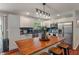 Bright kitchen with white cabinets, stainless steel appliances, and a wood-topped island at 4350 Sylvan Rd, Indianapolis, IN 46228