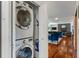 Stacked washer and dryer tucked into a closet with a view into the living room at 4350 Sylvan Rd, Indianapolis, IN 46228