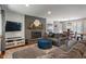 Comfortable living room with a brick fireplace, tv, and plush seating at 4350 Sylvan Rd, Indianapolis, IN 46228