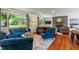 Bright living room featuring hardwood floors, comfortable seating, and large windows at 4350 Sylvan Rd, Indianapolis, IN 46228