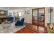 Cozy living room with hardwood floors, stylish furniture, and view to kitchen/office at 4350 Sylvan Rd, Indianapolis, IN 46228