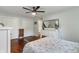 Light-filled main bedroom with wood floors, dresser and ceiling fan at 4350 Sylvan Rd, Indianapolis, IN 46228