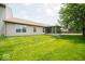 Expansive backyard with a well-maintained lawn and a charming screened-in porch at 4420 Victory Blvd, Indianapolis, IN 46203