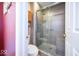 Modern bathroom featuring a glass-enclosed shower with tiled walls and a built-in seat at 4420 Victory Blvd, Indianapolis, IN 46203