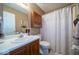 Cozy bathroom with a wood vanity, white sink, and a shower with a star-themed curtain at 4420 Victory Blvd, Indianapolis, IN 46203