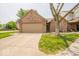 Charming brick home featuring an attached two-car garage and a well-manicured front lawn at 4420 Victory Blvd, Indianapolis, IN 46203