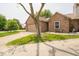 Charming brick home featuring an attached two-car garage and a well-manicured front lawn at 4420 Victory Blvd, Indianapolis, IN 46203