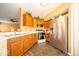 The kitchen features stainless steel appliances and wood cabinets at 4420 Victory Blvd, Indianapolis, IN 46203