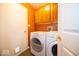 Convenient laundry room with a washer, dryer, and overhead storage cabinets at 4420 Victory Blvd, Indianapolis, IN 46203