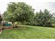 Lush backyard featuring a manicured lawn and a variety of trees at 47 Torrey Pine Dr, Brownsburg, IN 46112