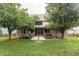 Scenic backyard with a basketball court, mature trees, and well-maintained lawn at 47 Torrey Pine Dr, Brownsburg, IN 46112