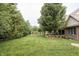 Expansive backyard featuring lush green lawn and mature trees, perfect for outdoor activities and relaxation at 47 Torrey Pine Dr, Brownsburg, IN 46112