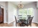 Cozy breakfast nook boasts a modern glass table and is surrounded by natural light from the window at 47 Torrey Pine Dr, Brownsburg, IN 46112