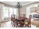 Formal dining room with a chandelier, large window, wood table and seating for six at 47 Torrey Pine Dr, Brownsburg, IN 46112