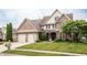 Traditional two-story brick home with a two-car garage and manicured lawn, presenting classic curb appeal at 47 Torrey Pine Dr, Brownsburg, IN 46112