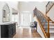 Elegant foyer with hardwood floors, staircase with iron railings, and arched doorways for a grand entrance at 47 Torrey Pine Dr, Brownsburg, IN 46112