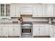 Well-lit kitchen with stainless steel range and appliances, white cabinets, and granite countertops at 47 Torrey Pine Dr, Brownsburg, IN 46112