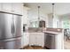 Open kitchen features stainless appliances, granite counters and convenient breakfast bar at 47 Torrey Pine Dr, Brownsburg, IN 46112
