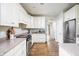Kitchen features stainless steel appliances, white cabinets and beautiful hardwood floors at 47 Torrey Pine Dr, Brownsburg, IN 46112