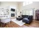 Spacious living room boasts a fireplace, built-in shelving, and large windows for ample natural light at 47 Torrey Pine Dr, Brownsburg, IN 46112