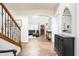 Open-concept living room with hardwood floors, staircase, and seamless transition to the living area at 47 Torrey Pine Dr, Brownsburg, IN 46112