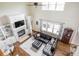 Bright living room featuring a fireplace, built-in shelving, and a comfortable black leather sectional at 47 Torrey Pine Dr, Brownsburg, IN 46112