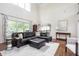 Expansive living room with hardwood floors, large windows, and a seamless flow to the kitchen at 47 Torrey Pine Dr, Brownsburg, IN 46112