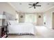 Bright main bedroom with a large bed, neutral carpet, white walls and light from many windows at 47 Torrey Pine Dr, Brownsburg, IN 46112