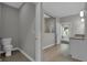 Bright bathroom featuring wood-look tile floors, walk-in shower, and a stylish vanity at 5076 Foxley Park Ln, Avon, IN 46123