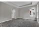 Primary bedroom boasts neutral grey colors, tray ceiling, and walk-in closet at 5076 Foxley Park Ln, Avon, IN 46123