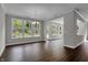 Open concept living room featuring dark hardwood floors and bright natural light at 5076 Foxley Park Ln, Avon, IN 46123