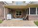 Charming covered back patio with brick flooring and comfortable seating area at 5194 Orahood Ct, Plainfield, IN 46168