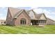 Well-maintained backyard featuring a brick patio and lush green lawn at 5194 Orahood Ct, Plainfield, IN 46168
