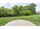 Spacious backyard with a stone patio surrounded by lush greenery at 5194 Orahood Ct, Plainfield, IN 46168