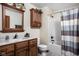 Bathroom with wooden vanity, cabinet, shower and tub combination, and neutral color palette at 5194 Orahood Ct, Plainfield, IN 46168