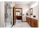 Bathroom featuring glass shower, double vanity sinks, and a view into the main bedroom at 5194 Orahood Ct, Plainfield, IN 46168