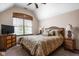 Bedroom featuring a full bed, ceiling fan, and large window with wooden trim at 5194 Orahood Ct, Plainfield, IN 46168