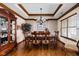 Formal dining room showcasing elegant wood trim, traditional furnishings, and a sophisticated chandelier at 5194 Orahood Ct, Plainfield, IN 46168