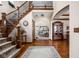 Grand foyer featuring a sweeping staircase, hardwood floors, and open views to other living spaces at 5194 Orahood Ct, Plainfield, IN 46168