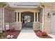 Inviting front porch with stone and brick accents, featuring a cozy bench and decorative landscaping at 5194 Orahood Ct, Plainfield, IN 46168