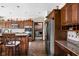 Well-equipped kitchen with custom wood cabinets, granite countertops, and stainless steel appliances at 5194 Orahood Ct, Plainfield, IN 46168