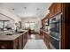 Modern kitchen featuring custom cabinetry, granite counters, stainless steel appliances and eat-in dining area at 5194 Orahood Ct, Plainfield, IN 46168