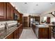 Spacious kitchen with granite countertops, stainless steel appliances, and dark wood cabinetry at 5194 Orahood Ct, Plainfield, IN 46168