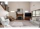 Inviting living room with a cozy fireplace, comfortable seating, and an open view of the staircase at 5194 Orahood Ct, Plainfield, IN 46168